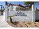 Allure Townhomes entrance with white brick wall, desert landscaping, and secure gated entry at 928 Allure Dr, Las Vegas, NV 89128