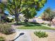 Well-manicured front yard with mature trees and lush green grass in a peaceful community at 928 Allure Dr, Las Vegas, NV 89128