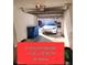 Oversized one-car garage featuring a vehicle, some shelving, and two garbage cans at 928 Allure Dr, Las Vegas, NV 89128