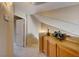 Upstairs hallway featuring wooden cabinets, carpet, and a charming floral display at 928 Allure Dr, Las Vegas, NV 89128