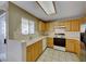 Cozy kitchen with wood cabinets, a window view, and classic white appliances at 928 Allure Dr, Las Vegas, NV 89128