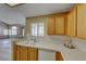 Bright kitchen features wood cabinets, tile countertops, and a view to the living area at 928 Allure Dr, Las Vegas, NV 89128