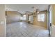 Bright living room with high ceilings, clerestory window and slider door, neutral paint and tile at 928 Allure Dr, Las Vegas, NV 89128