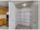 Organized pantry with white shelving and ample storage space adjacent to the kitchen at 928 Allure Dr, Las Vegas, NV 89128