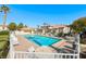 Community pool surrounded by lounge chairs and lush landscaping under a clear blue sky at 928 Allure Dr, Las Vegas, NV 89128