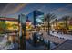 Modern town center with water feature, palm trees, and contemporary buildings for shopping and leisure at 928 Allure Dr, Las Vegas, NV 89128