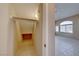 Long walk-in closet with shelves and a rod; tile floors lead to an arched window at 928 Allure Dr, Las Vegas, NV 89128