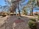 Serene backyard featuring desert landscaping, mature trees, and manicured shrubs at 9437 January Dr, Las Vegas, NV 89134