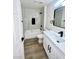 Bathroom featuring a shower with black hardware, white vanity, and ample counter space at 9437 January Dr, Las Vegas, NV 89134