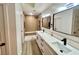 Bathroom featuring a double vanity sink and shower with a seat and modern hardware at 9437 January Dr, Las Vegas, NV 89134