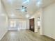 Bright living room featuring a fireplace, vaulted ceiling, fan, and luxury vinyl plank flooring at 9437 January Dr, Las Vegas, NV 89134