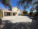 Backyard with gravel area, covered patio and lush trees at 9543 Antelope Bend Ct, Las Vegas, NV 89148