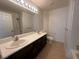 Bathroom featuring double sinks, tile floor, shower and tub combo at 9543 Antelope Bend Ct, Las Vegas, NV 89148