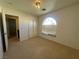 Bedroom with neutral carpet, arched window and double closets at 9543 Antelope Bend Ct, Las Vegas, NV 89148