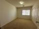 Neutral bedroom with carpet, blinds, and white closet doors at 9543 Antelope Bend Ct, Las Vegas, NV 89148