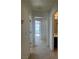 Hallway with carpet, white walls, and open doorways at 9543 Antelope Bend Ct, Las Vegas, NV 89148