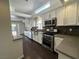 Stylish kitchen featuring modern appliances, light countertops, and dark hardwood flooring at 9543 Antelope Bend Ct, Las Vegas, NV 89148