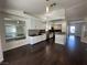 Open floor plan kitchen showcasing white cabinets, dark countertops, stainless steel appliances, and hardwood flooring at 9543 Antelope Bend Ct, Las Vegas, NV 89148