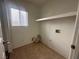 Compact laundry room featuring tile flooring, a utility shelf, and washer/dryer hookups at 9543 Antelope Bend Ct, Las Vegas, NV 89148