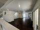 Spacious living room with dark hardwood floors connects to the kitchen and outdoor covered patio at 9543 Antelope Bend Ct, Las Vegas, NV 89148