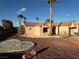 Charming home with a tile roof, desert landscaping, and mature palm trees on a sunny day at 9552 Gold Bank Dr, Las Vegas, NV 89134