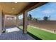 Covered back patio with artificial turf and brick pavers at 10089 Bismuth St, Las Vegas, NV 89183