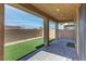 Covered back patio with brick pavers and artificial turf for low-maintenance outdoor living at 10089 Bismuth St, Las Vegas, NV 89183