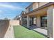 Backyard with a covered patio, artificial turf and low-maintenance landscaping at 10089 Bismuth St, Las Vegas, NV 89183