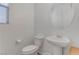 Elegant half bathroom with a pedestal sink, modern toilet, and stylish fixtures at 10089 Bismuth St, Las Vegas, NV 89183