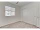 Bedroom features a large window for ample natural light and a paneled closet door at 10089 Bismuth St, Las Vegas, NV 89183