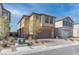 Two-story home with a paved driveway, two-car garage, and low maintenance landscaping at 10089 Bismuth St, Las Vegas, NV 89183