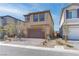 Two-story home with a paved driveway, two-car garage, and low maintenance landscaping at 10089 Bismuth St, Las Vegas, NV 89183