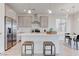 Bright kitchen with stainless steel appliances, island with seating, and pendant lighting at 10089 Bismuth St, Las Vegas, NV 89183