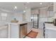 Modern kitchen with stainless steel appliances and a center island with barstool seating at 10089 Bismuth St, Las Vegas, NV 89183