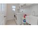 Laundry room features a washer and dryer set, utility sink, and ample shelving at 10089 Bismuth St, Las Vegas, NV 89183