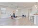 Bright living room with tile flooring, minimalist decor, flowing into the kitchen, offering versatile design options at 10089 Bismuth St, Las Vegas, NV 89183