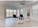 Bright living room with tile flooring, minimalist decor, a ceiling fan and sliding doors for natural light at 10089 Bismuth St, Las Vegas, NV 89183