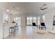 Open-concept living space features tile flooring, modern lighting, access to backyard, and a kitchen island with seating at 10089 Bismuth St, Las Vegas, NV 89183
