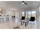 Bright, open-concept living space with tile flooring, modern furnishings, and sliding glass doors to the backyard at 10089 Bismuth St, Las Vegas, NV 89183