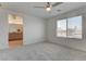 Spacious main bedroom offers bathroom access, a large window and ceiling fan at 10089 Bismuth St, Las Vegas, NV 89183