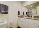 Bathroom featuring white cabinets, granite countertop, toilet and shower with patterned curtain at 1132 Ruby Sparrow St, Henderson, NV 89011