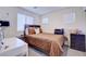 Bedroom with carpet, windows, a wooden headboard bed and side table with lamps at 1132 Ruby Sparrow St, Henderson, NV 89011