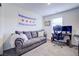 Bonus room with a comfortable gray sofa, desk, chair and computer setup at 1132 Ruby Sparrow St, Henderson, NV 89011