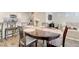 Open dining area with a wood table, adjacent to a modern kitchen and a comfortable living space at 1132 Ruby Sparrow St, Henderson, NV 89011