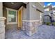Inviting front entrance with a yellow door and decorative stone accents at 1132 Ruby Sparrow St, Henderson, NV 89011