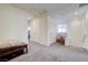 Bright hallway with neutral carpet, white walls, storage closet and natural light from the window at 1132 Ruby Sparrow St, Henderson, NV 89011