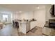 Open kitchen features granite countertops, island, stainless steel appliances, and wood-look floors at 1132 Ruby Sparrow St, Henderson, NV 89011