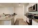 Kitchen features granite countertops, stainless steel appliances, and white cabinetry at 1132 Ruby Sparrow St, Henderson, NV 89011