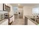 Well-lit kitchen featuring stainless steel appliances, granite countertops, and center island at 1132 Ruby Sparrow St, Henderson, NV 89011