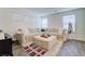 Comfortable living room with a plush sectional sofa, ottoman, and ample natural light at 1132 Ruby Sparrow St, Henderson, NV 89011